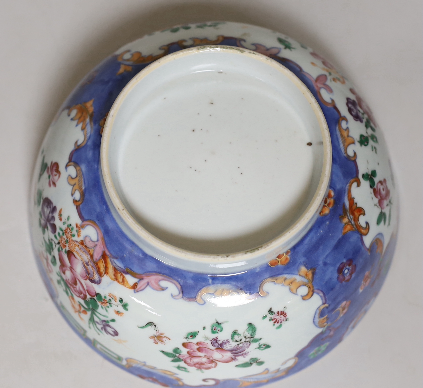 A Chinese famille rose bowl, Qianlong period, painted with insects amongst flowers, 23cm in diameter